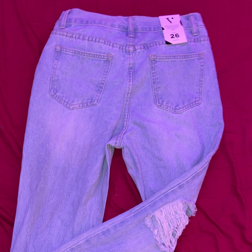 Ripped bell bottom jeans.